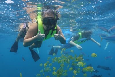 Oahu Dolphin and Snorkel Tour with Waikiki Pickup & Lunch - Onboard setup: snorkel gear, life jackets, and the 20-foot slide